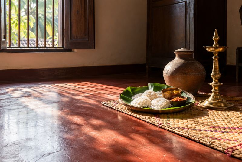 String hoppers on a banana leaf in a sunlit family house