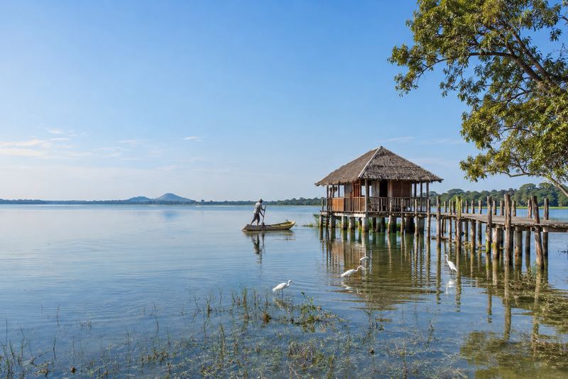 A floating timber cabana on a sunlit ancient reservoir