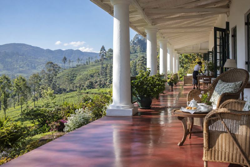 A planter's bungalow veranda with tea set for two in sunshine