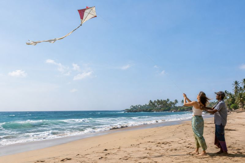 A handmade kite flying over a sunny south-coast beach