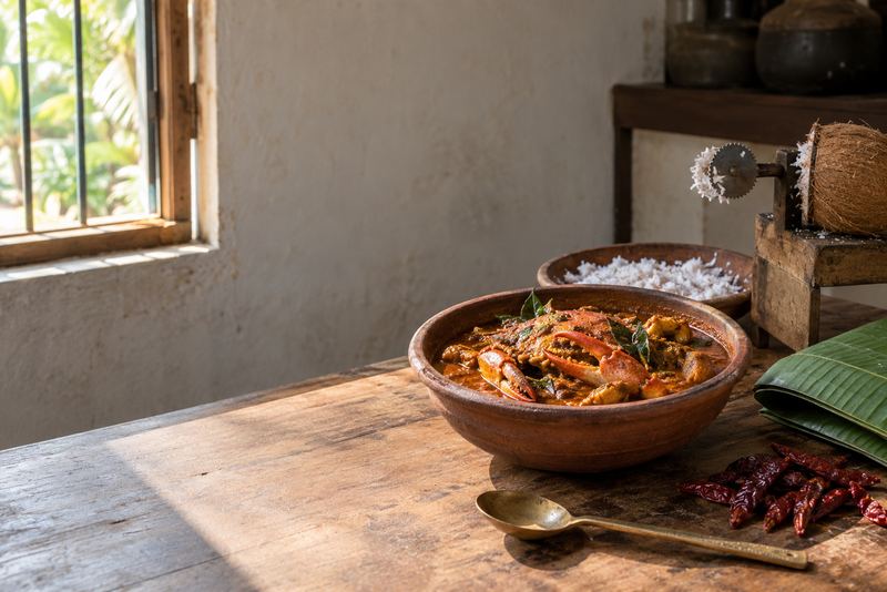 A crab curry in a clay bowl on a Jaffna kitchen table