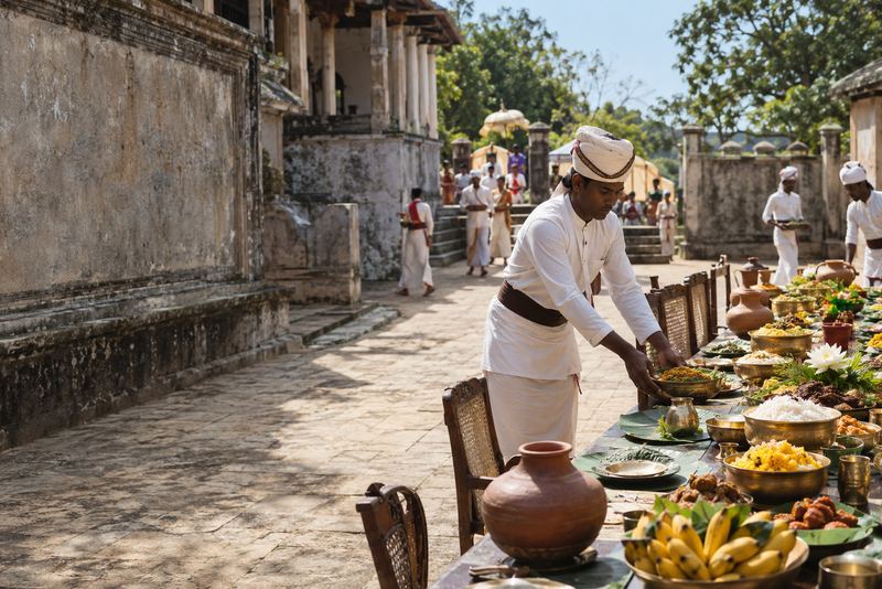 A royal feast table set in a sunlit stone courtyard