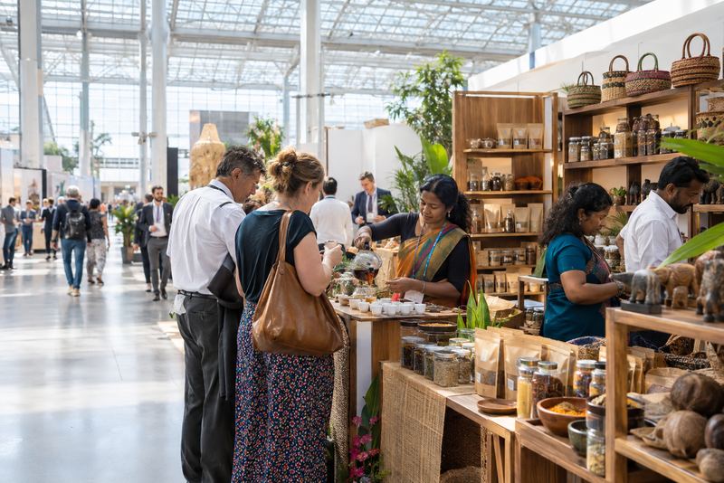 Sri Lankan producers pouring tea for buyers at a fair stand