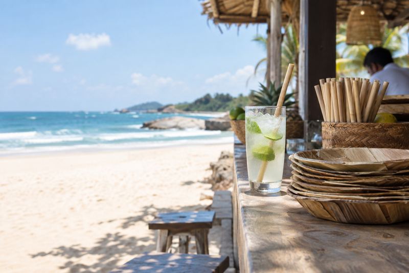 Coconut-leaf straws and plates on a sunny beach café counter