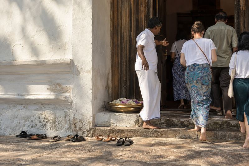 Visitors' sandals at the step of an old place of worship