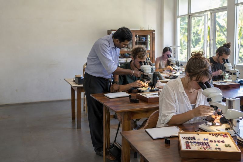 Foreign students studying gems at microscopes in Ratnapura