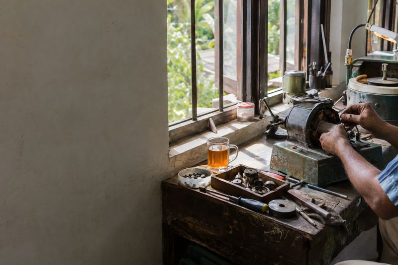 A technician repairing a gem-cutting machine motor