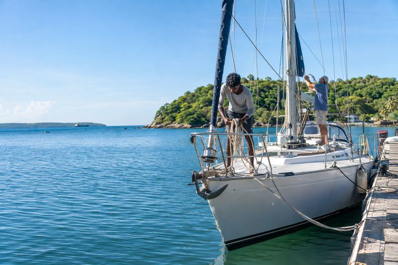 A sailing yacht at a wooden pontoon in Trincomalee harbour