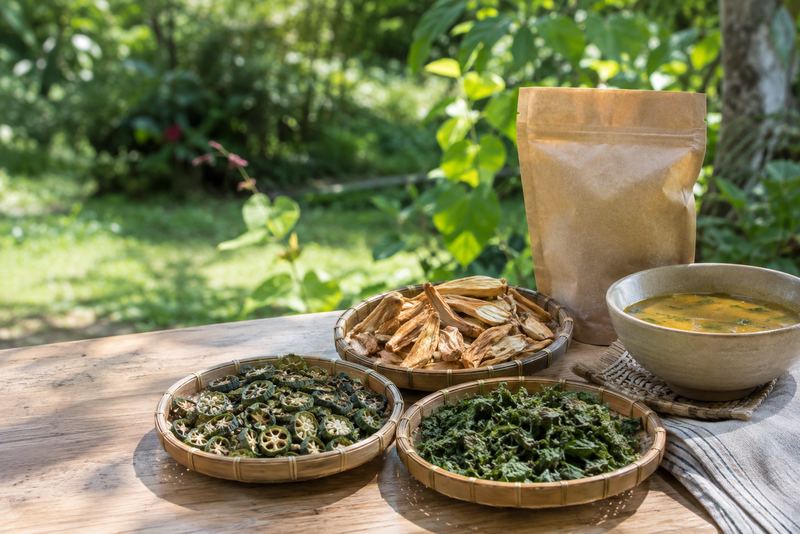 Dried okra, jackfruit and gotukola in woven trays