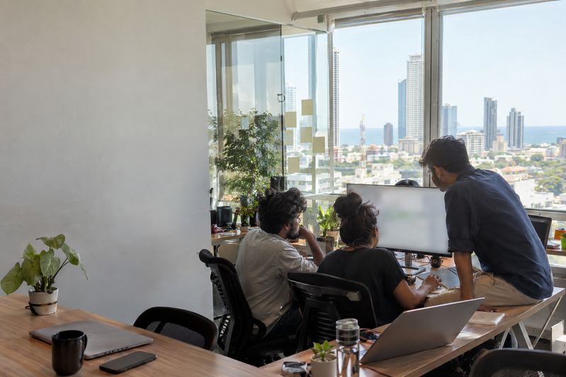 A small software team gathered round one monitor in Colombo