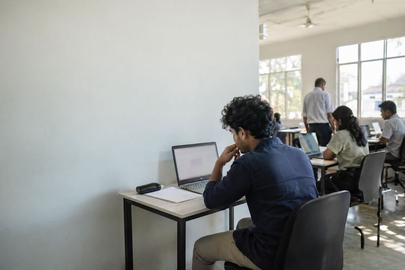A developer sitting a supervised test in a sunny room