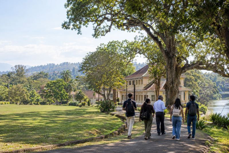 Visiting students walking with a lecturer at Peradeniya