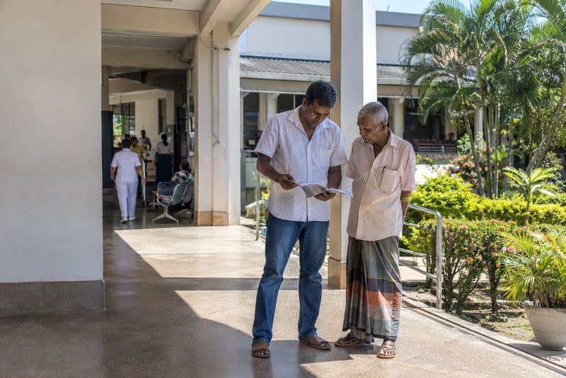 A son and his father with a hospital directory