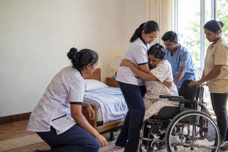 Trainees practising a safe transfer to a wheelchair