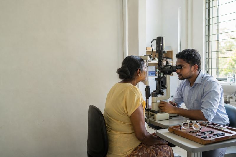 An optometrist examining a patient's eyes at a clinic