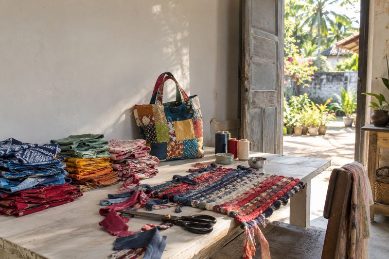 Sorted garment off-cuts becoming bags and rugs in sunlight