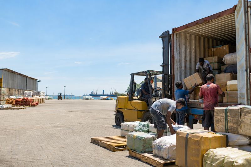 Many small consignments loaded into one container in sunshine