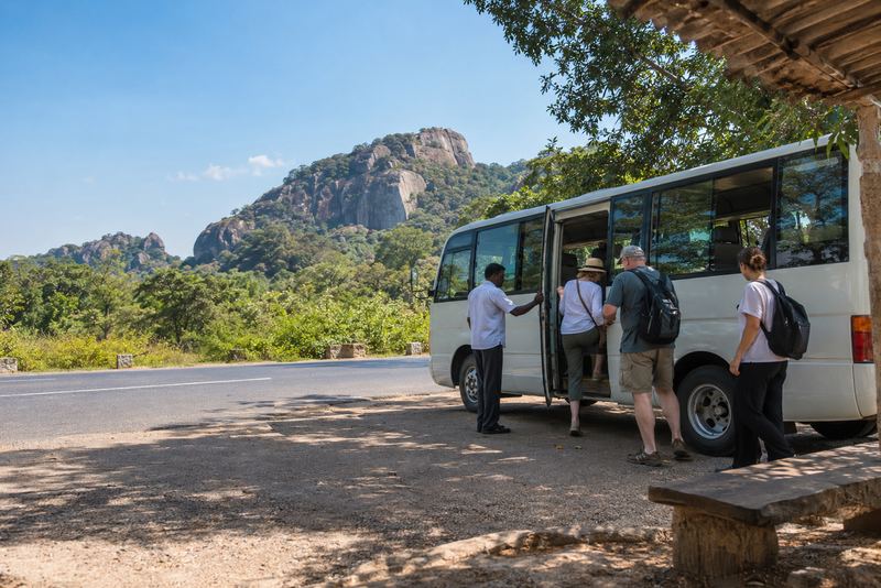 Visitors boarding a tourist shuttle near Dambulla