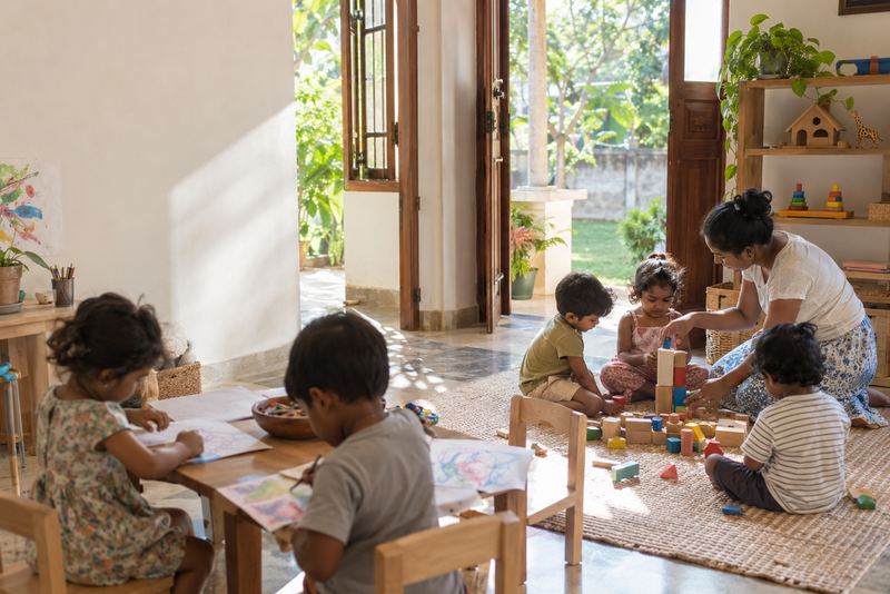 Children playing with blocks in a sunny childcare room