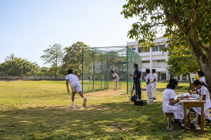 After-school cricket and painting on a sunny school field