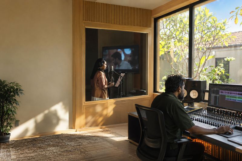 A voice actor dubbing a film in a bright studio