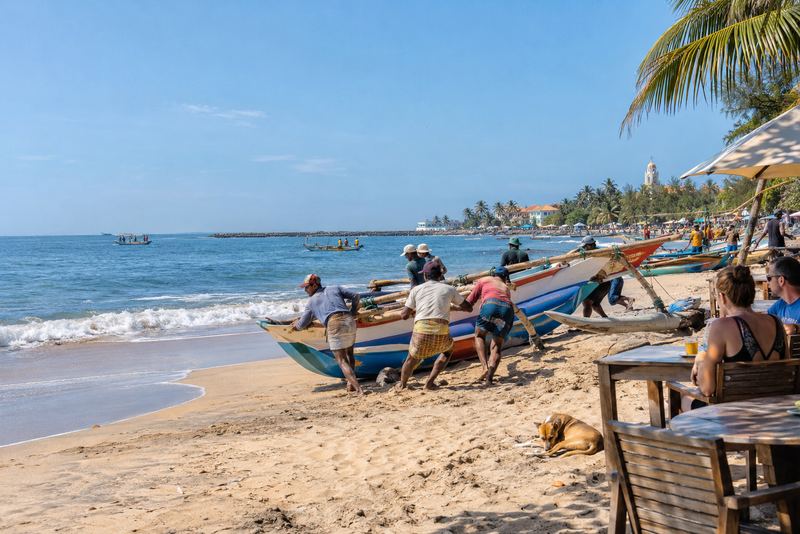 Fishing boats hauled onto sunny Negombo beach